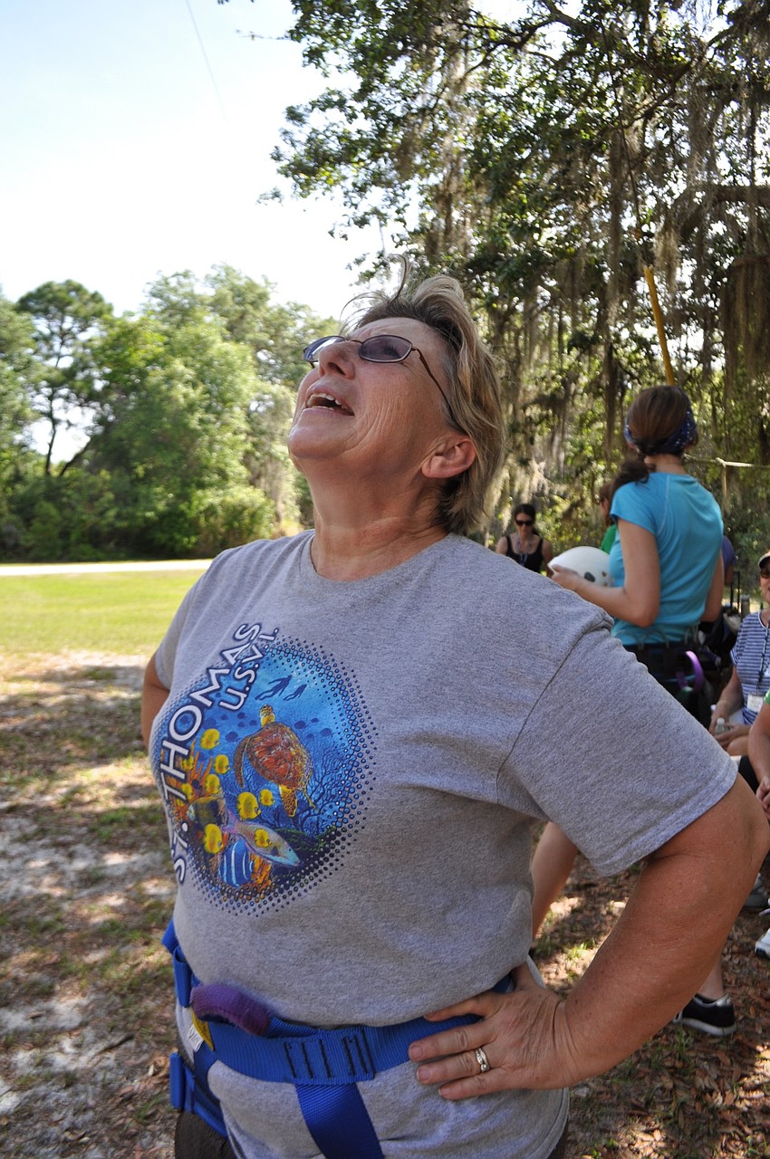 Lori Denny cheers on another participant as she attempts the rock wall.