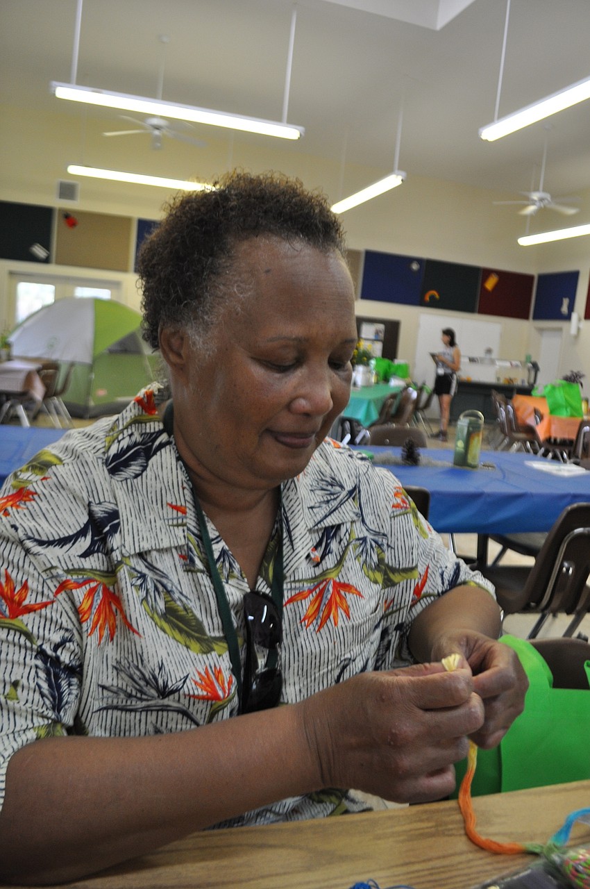 Gaye Freedman makes a bracelet.