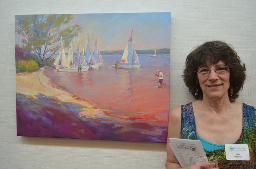 Julie Hanson with her painting, “City Island Sailboats”