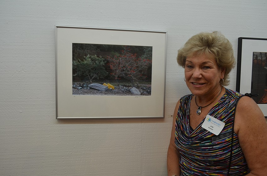 Judy Kramer with her painting, “Rowboat Rendezvous 2”