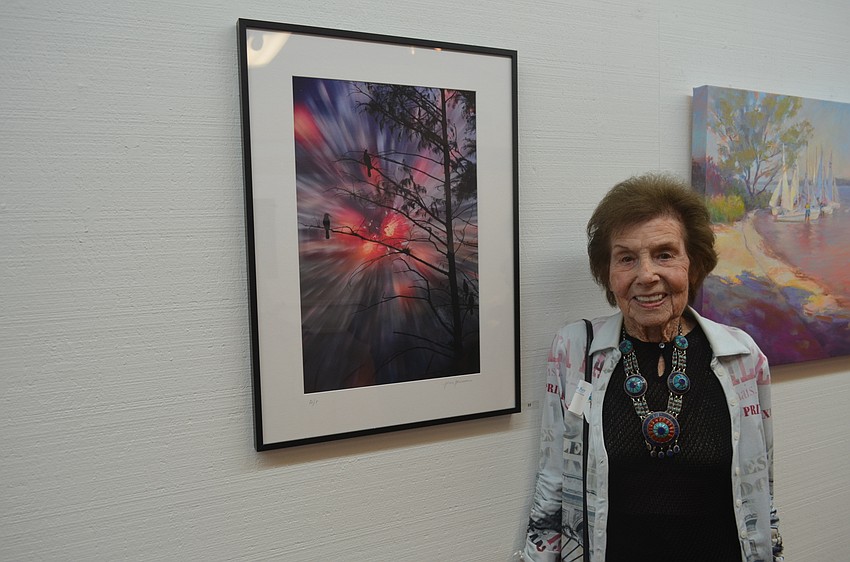 Jean Germain with her painting, “Birds at Loxahatchee, FL”