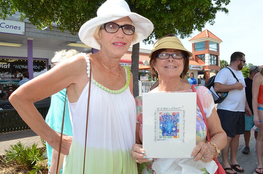 Donna Nickerson and Kathy Meltebrink with a purchase from Julie Goodin Mixed Media.