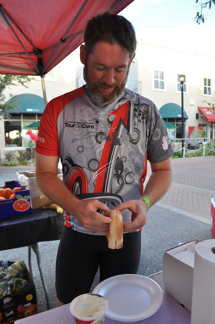 Bryan Balak grabs a bagel before his 62-mile ride.