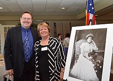 Curator for the Ca‘dZan Ron McCarty and Sarasota Garden Club President Olivia Haynes with a portrait of Mable Ringling from 1905.