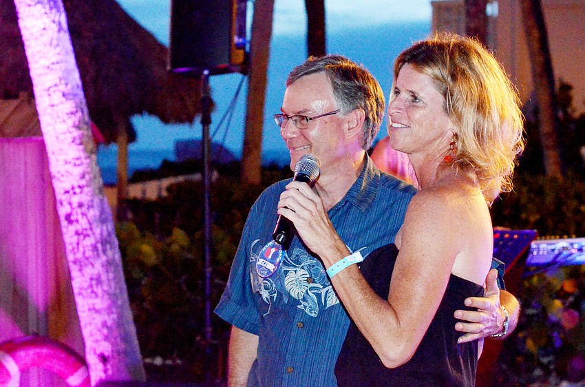 Jay Brady on stage with Lisa Bechtold while the crowd sings him ‘Happy Birthday.’