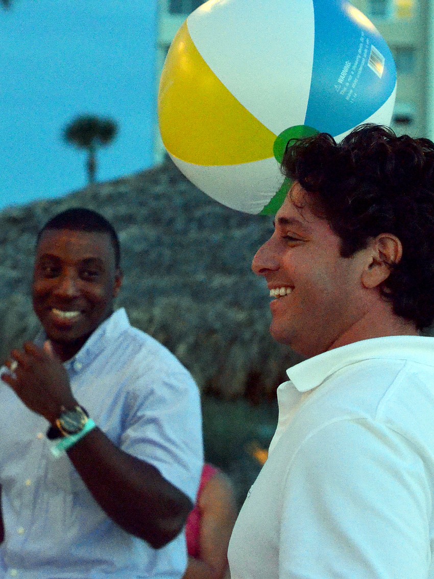 Ryan Ackerman catches the beach ball during a game at Take Stock in Children’s Sailors & Sandals event.