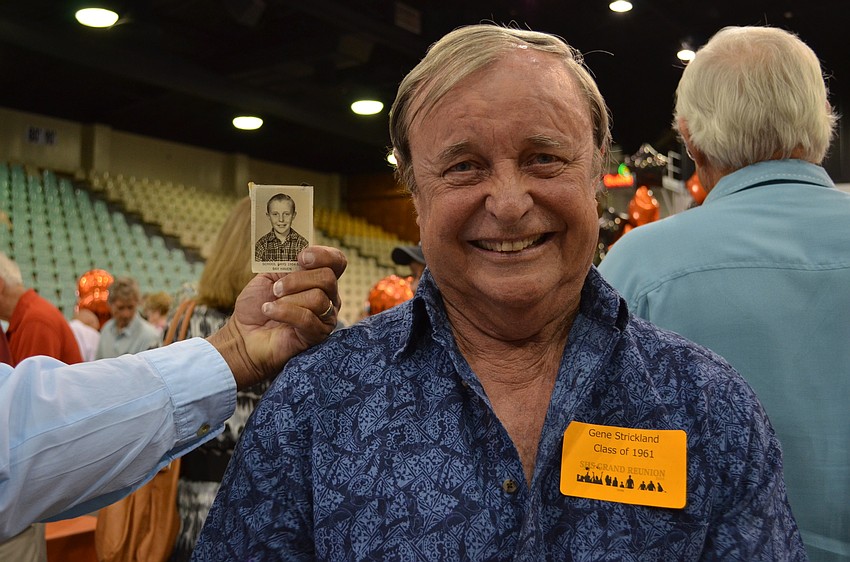 Gene Strickland with a photo of him as a student at Bay Haven School of Basics Plus.