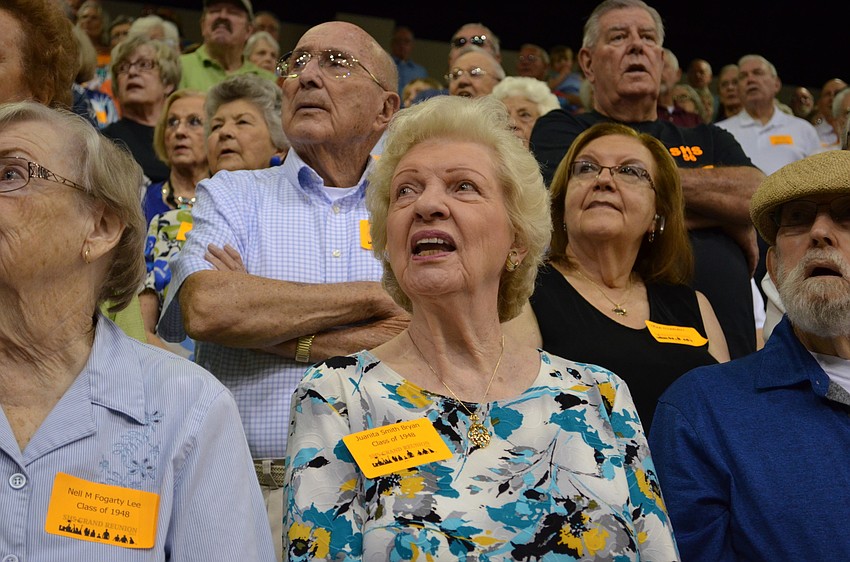 Juanita Smith Bryan sings along with the alma mater song.