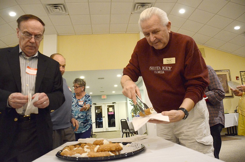 Board member Bob Farrell gets a cannoli for dessert.