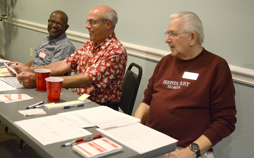Kumar Mahadevan, Ted Ritter and Bob Farrell help people sign in at the annual dinner.