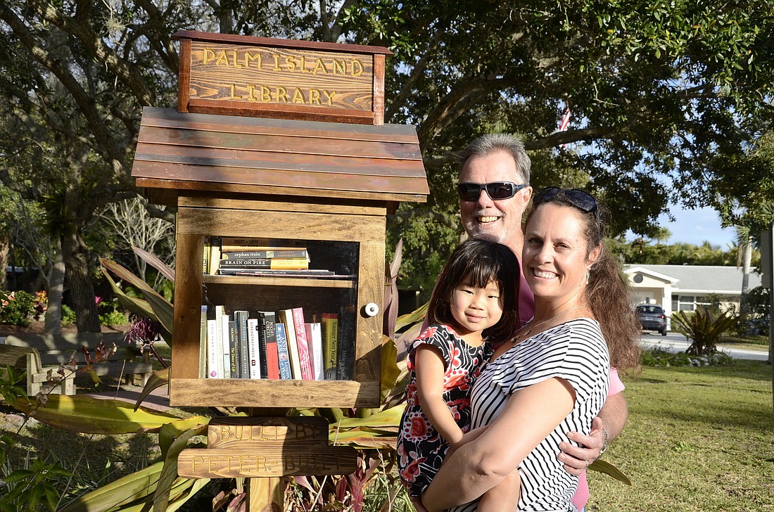 Richard and Alison Light, and their daughter, Chloe Jane, donated the Little Free Library to their community. Photos by Jessica Salmond