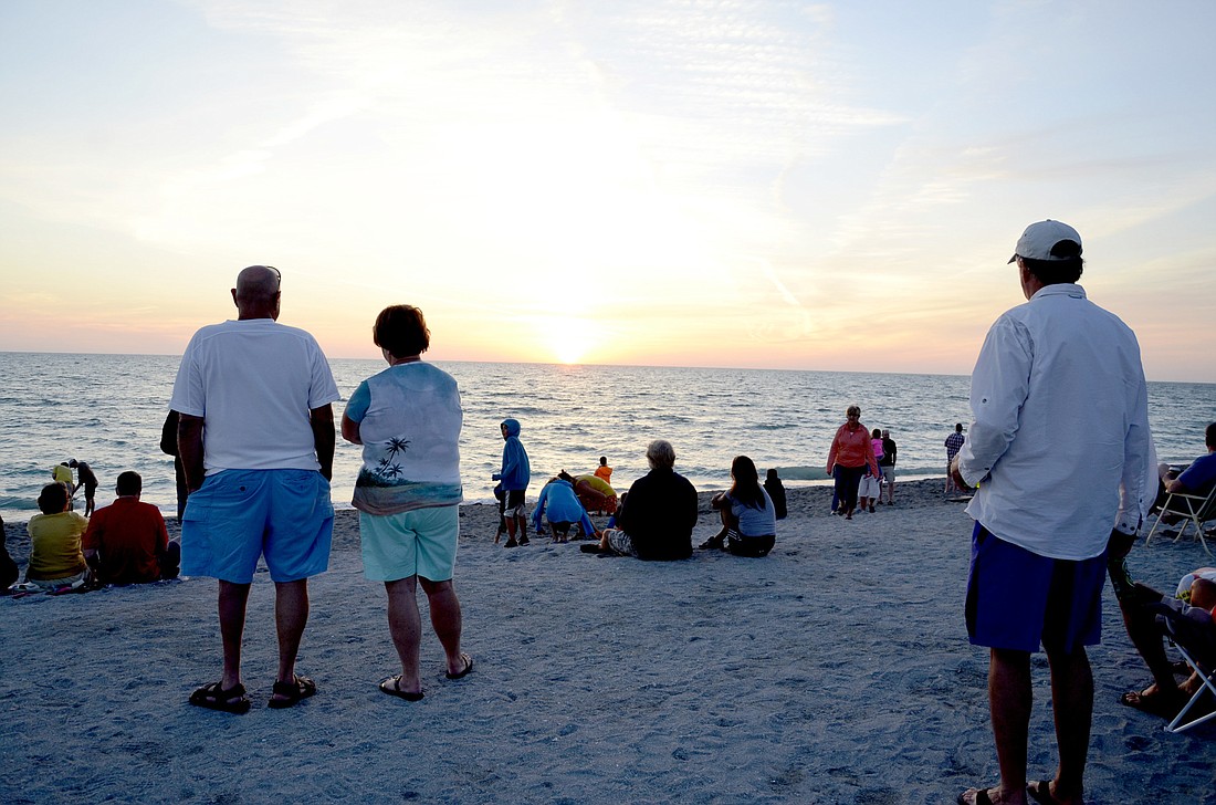 Sunset-watchers gather on Turtle Beach.