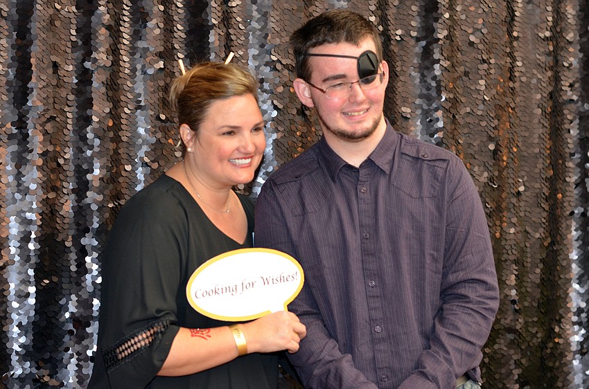 Rebecca Blitz and Jamie Myers pose in the photo booth at Cooking for Wishes.