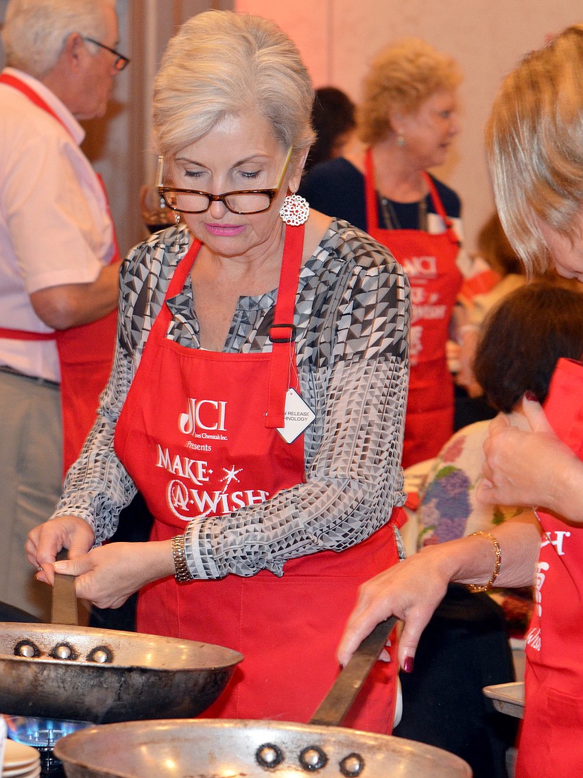 Pat Crincoli cooks the first course for her table at Cooking for Wishes ‘Taste of Asia.’