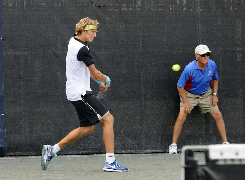 Seventeen-year-old Alexander Zverev of Germany sends the ball back over the net.