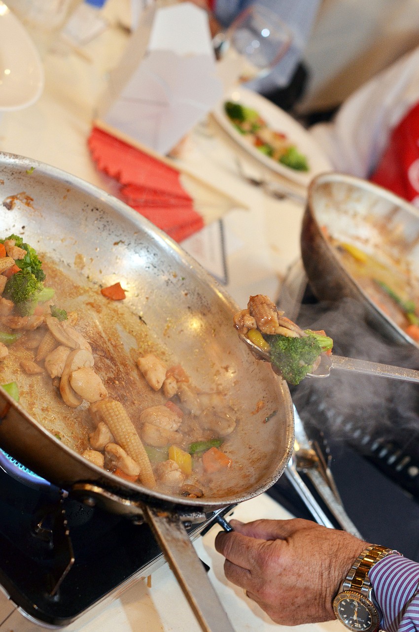 Guests prepared the ‘Taste of Asia’ menu at Cooking for Wishes Thursday, Feb. 26, at Michael’s On East.