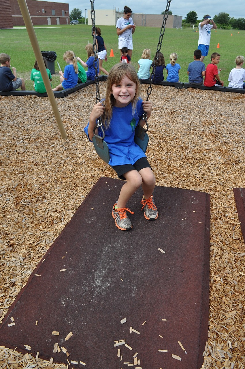 Jeana-Marie Jason, 7, takes some swing time.