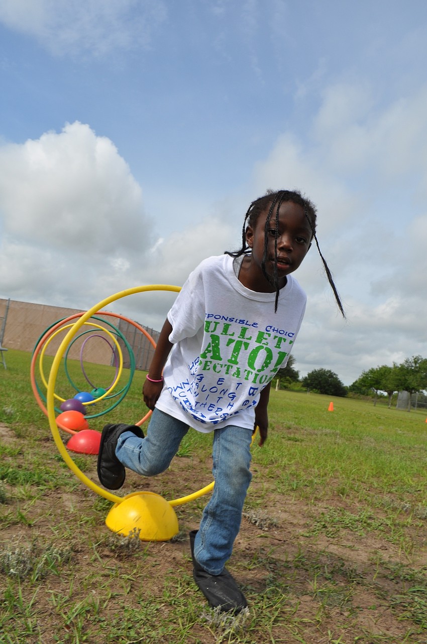 Donesha Reed, 7, makes the hula-hoop obstacle look easy.