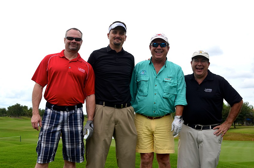 Rick Bennett, Chris DeLeonardo, Bill Baker and Nick Lanese celebrate a birdie.
