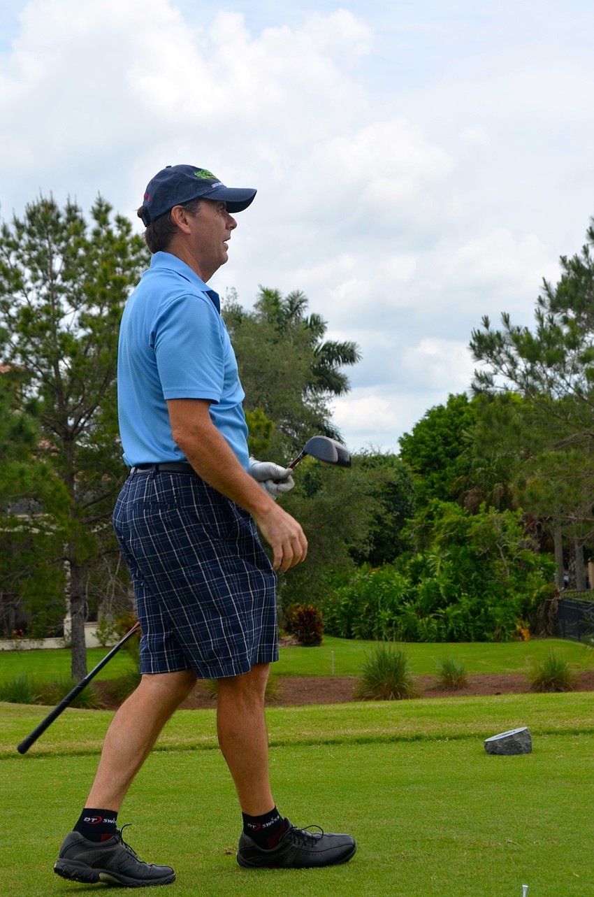 Mike Babinec admires his shot off the green and toward his target.
