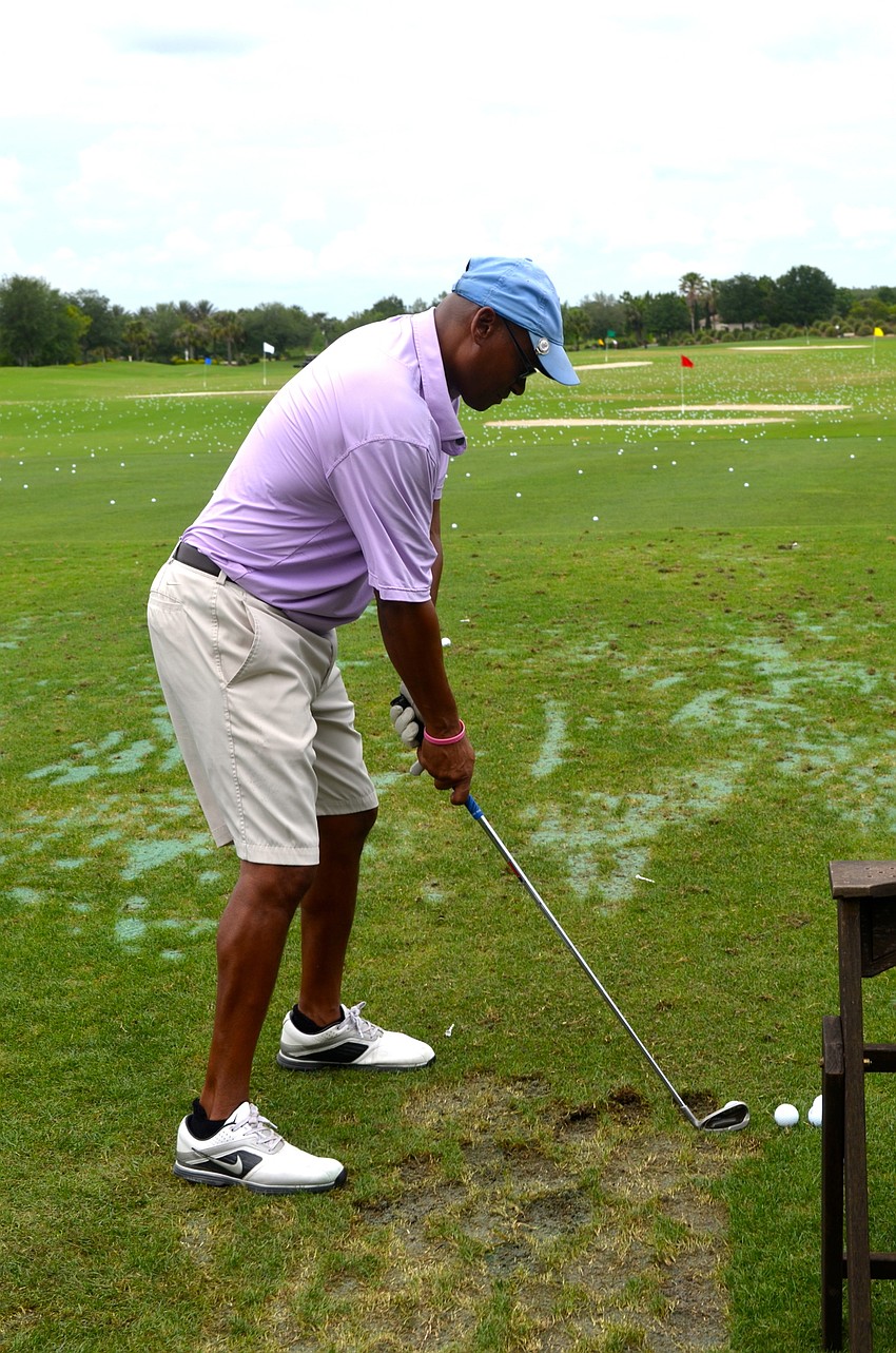 Brian Ellerson takes a few practice shots before competing in the tournament.