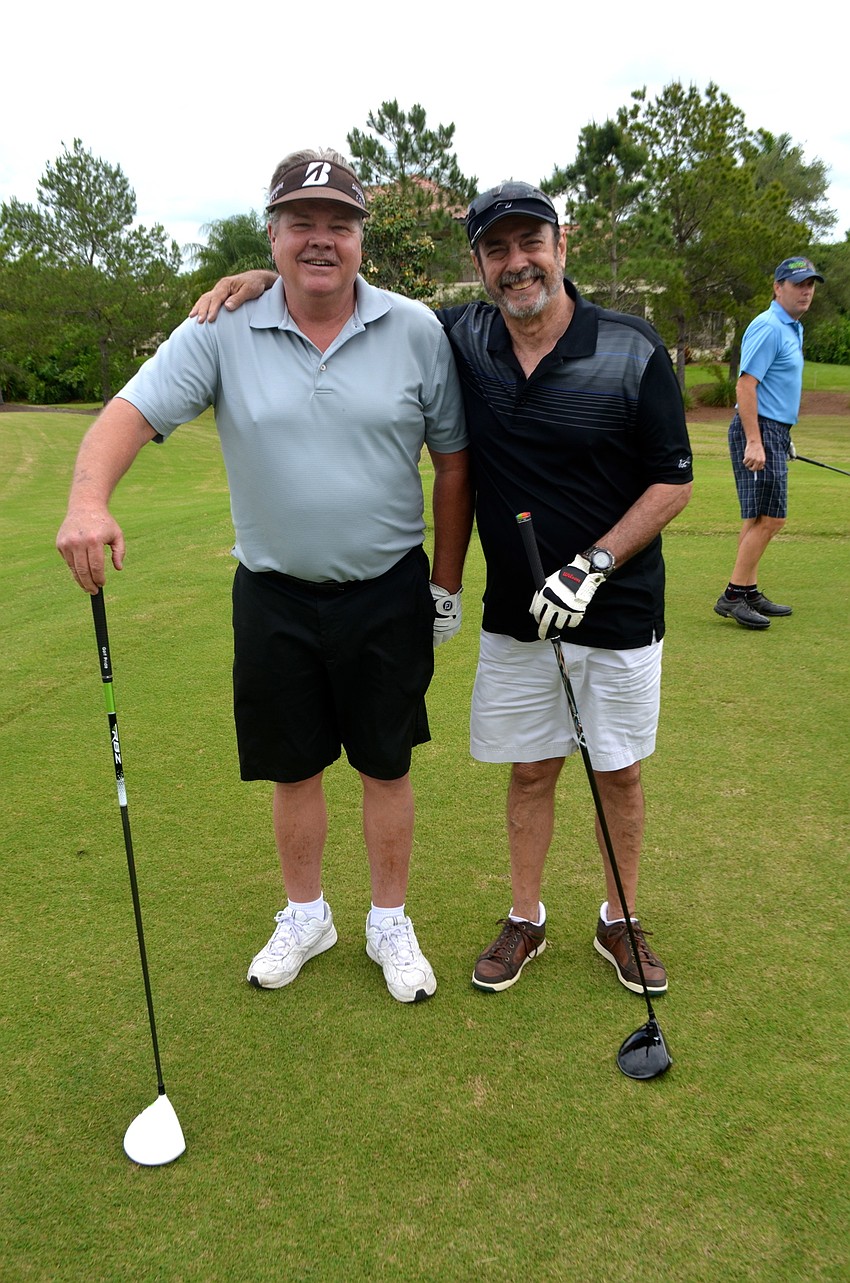 Tom Herrmann and Chris Gorrell pose for a photo opp. before their turns at the tee.