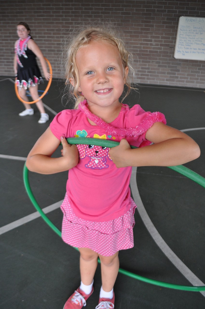 Alexa Anspach, 5, is all smiles while she attempts to hula hoop.
