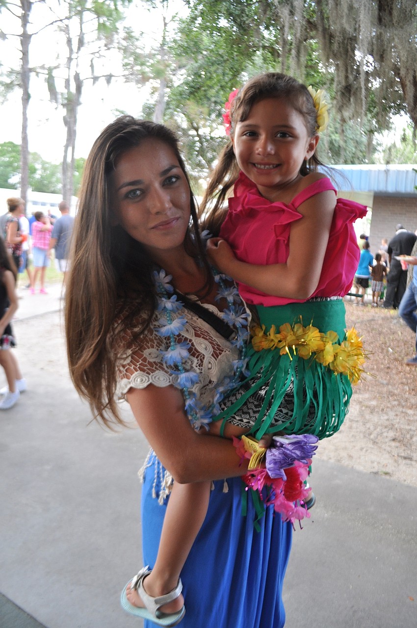 Neiel and Abigail Gutierrez, 5, enjoy their first luau.