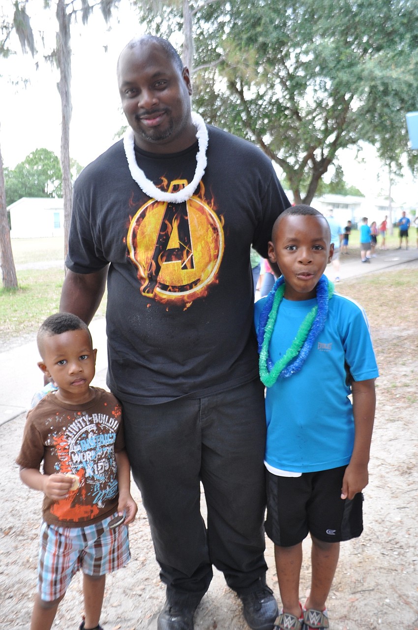 Jermaine Christmas, center, attends with his sons, Elijah, left, and Tremaine, 6.
