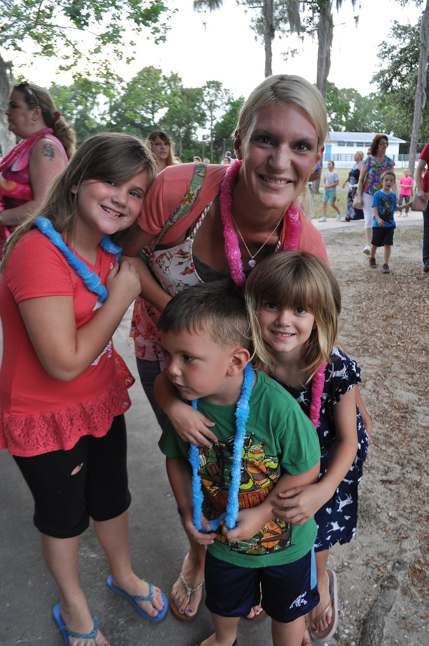 Katie Everett attends with her children, Olivia Everett, Evan Vincy and Ava Everett.