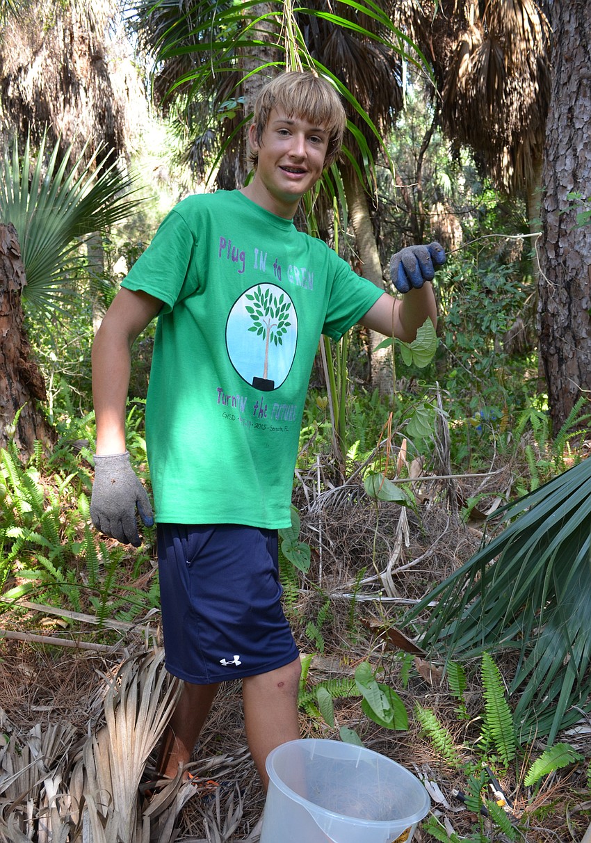 Jack Kempton shows off a piece of the invasive vine.