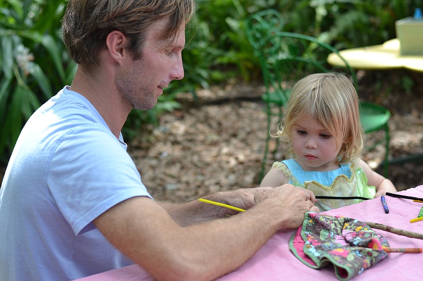 David and Isla Outerbridge work together on a craft project at the Hug-a-Tree event at Sarasota Children's Garden.