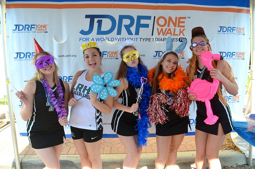 Lakewood Ranch High cheerleaders Natalie Fonseca, Sophia Masterson, Emilee Bierwirth, Kara Mathis and Sierra Ellis play around with the event’s photo booth.
