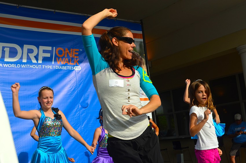 Gina Hogue leads the crowd during a fast-paced Zumba lesson.