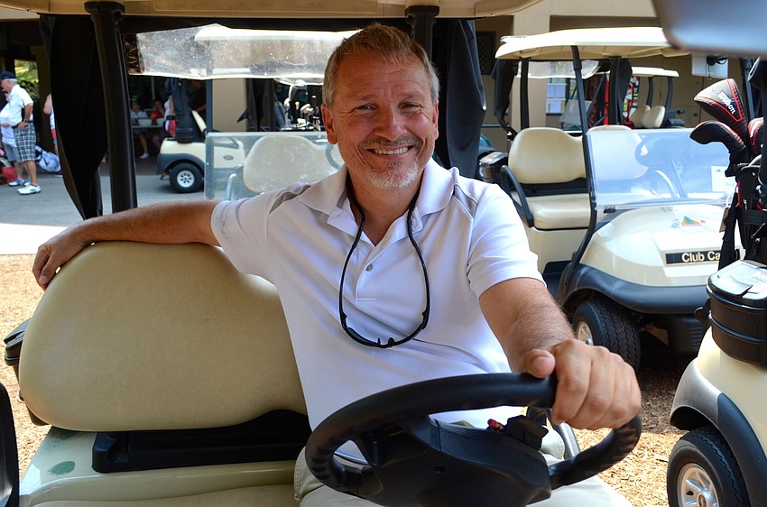 Chuck Alfrey waits for the tournament to start from the comfort of a golf cart.