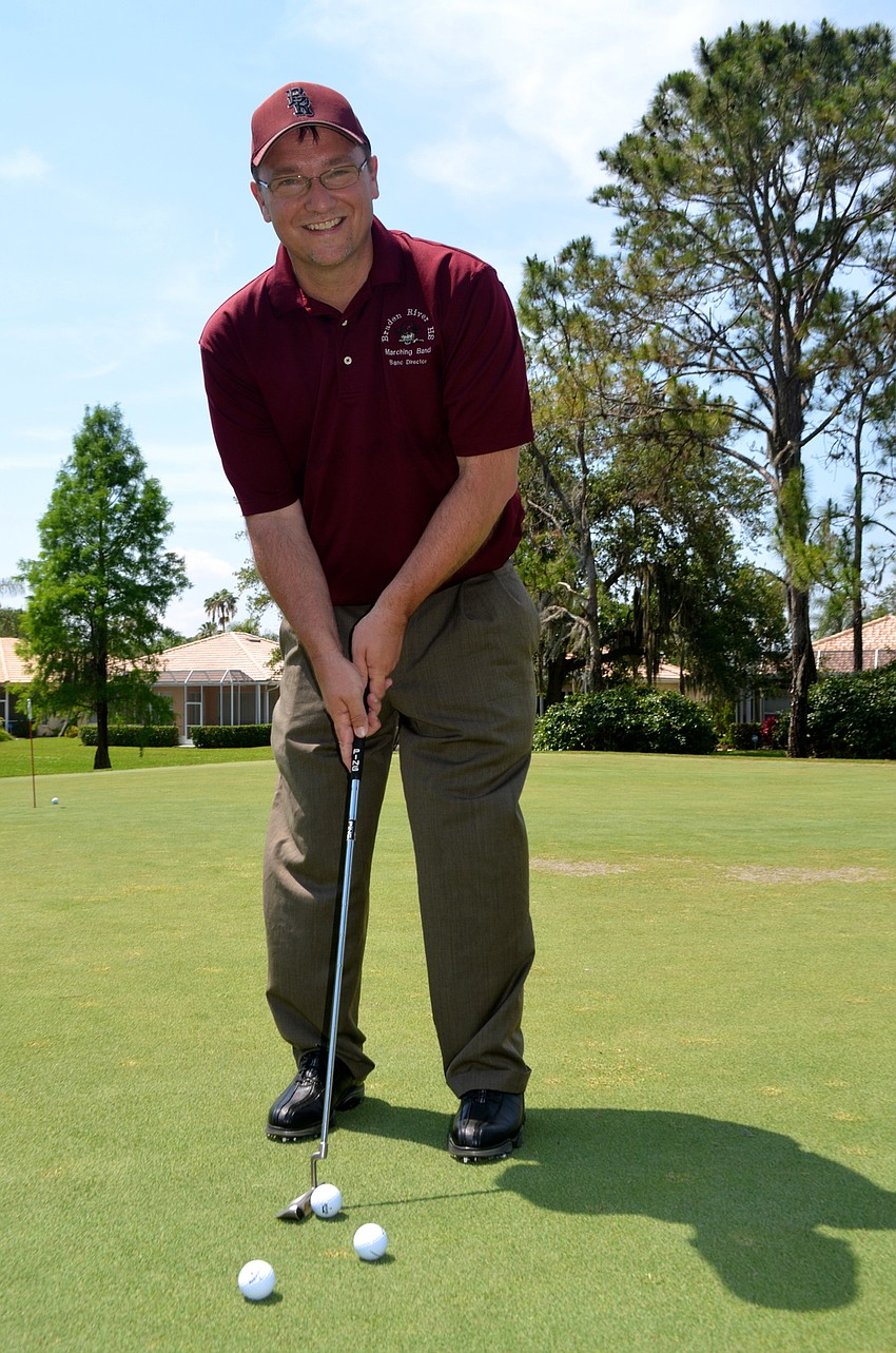 Band Director Kendall Carrier perfects his golf game before the tournament starts.