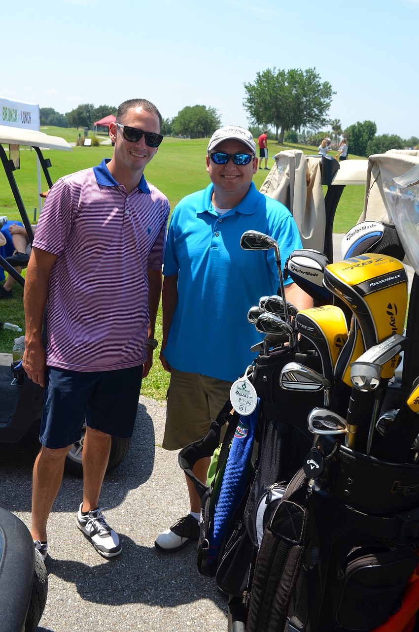 Mike Meadows and Spencer Rasnake get their clubs and putters secured before heading onto the course.