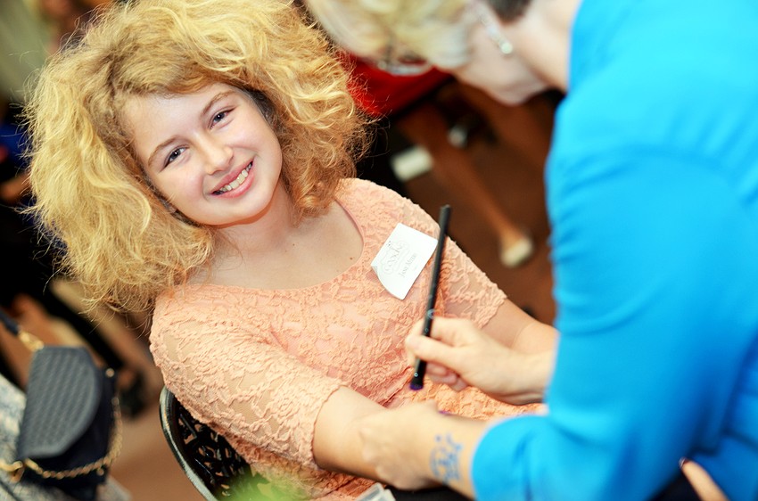 Jayne Meyers gets a glitter tattoo at Cooking for Wishes.