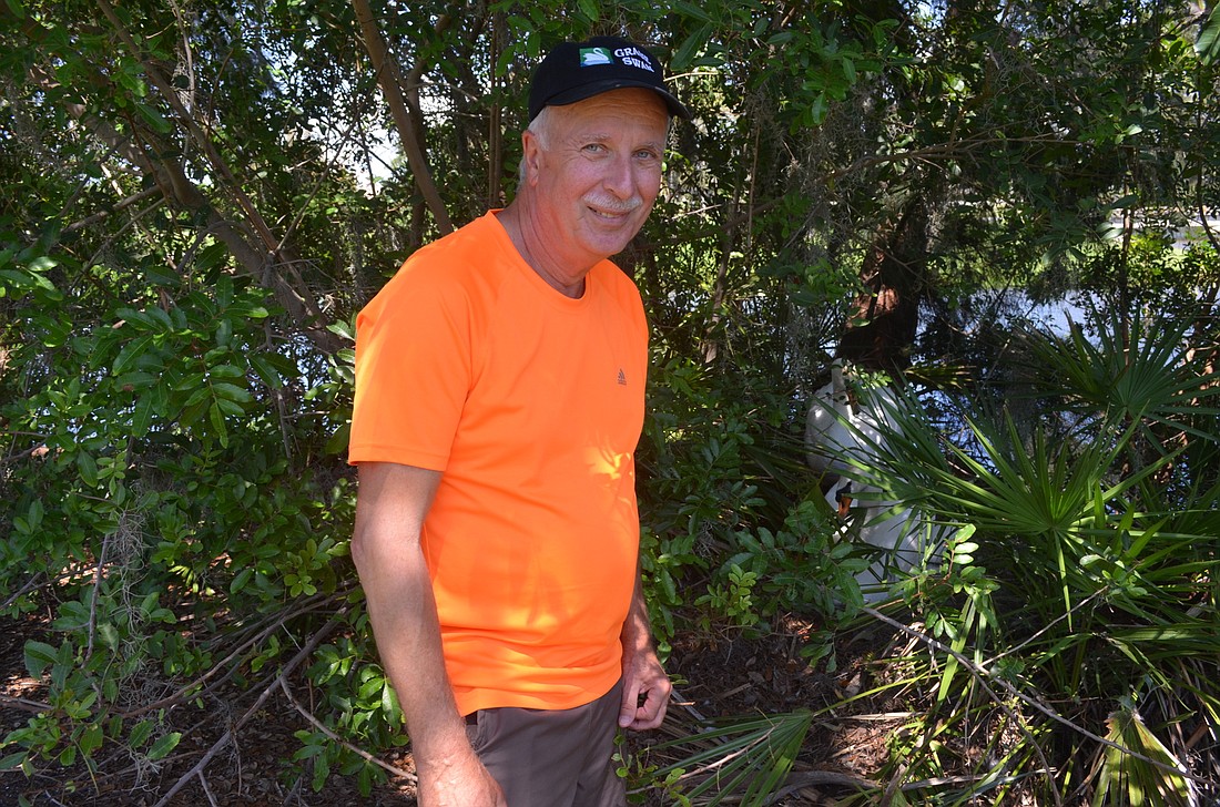 David Novak cares for 15 swans at Harbourside and Islandside, including two breeding pairs that are currently in nesting mode. Photo by Kristen Herhold