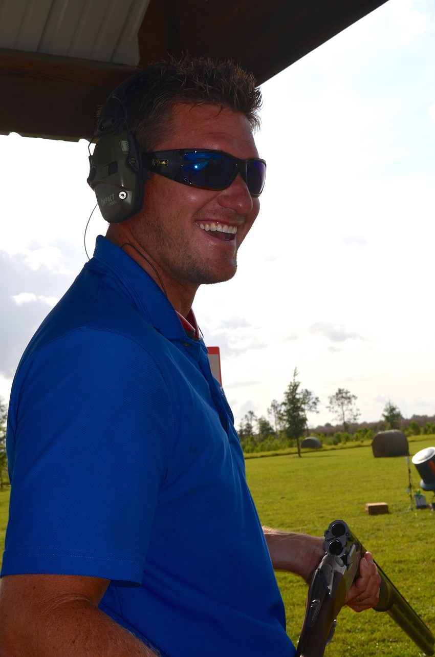 Robbie Sanger laughs with his team before taking his first shot of the day.