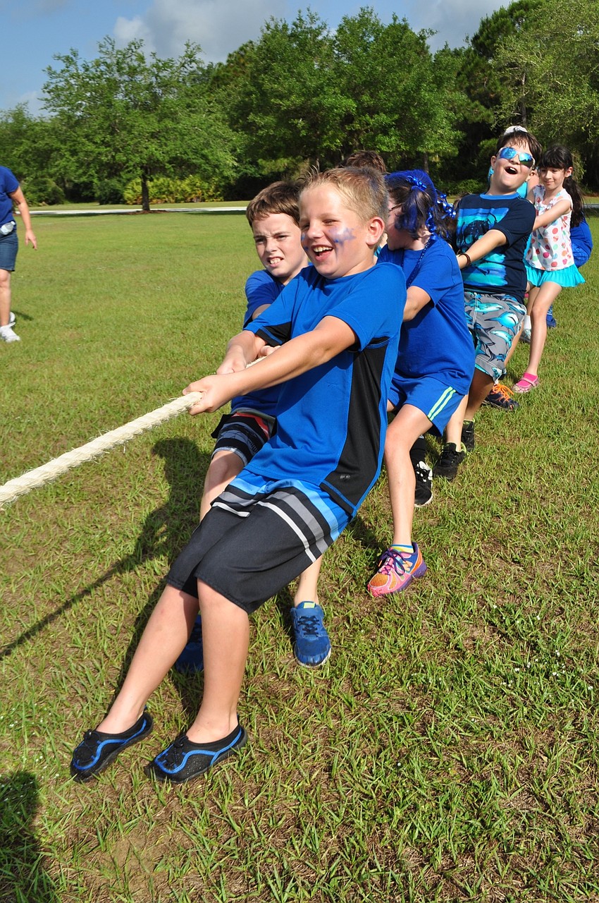 Alex Brown, 9, has the front spot for the blue team in the tug-of-war game.
