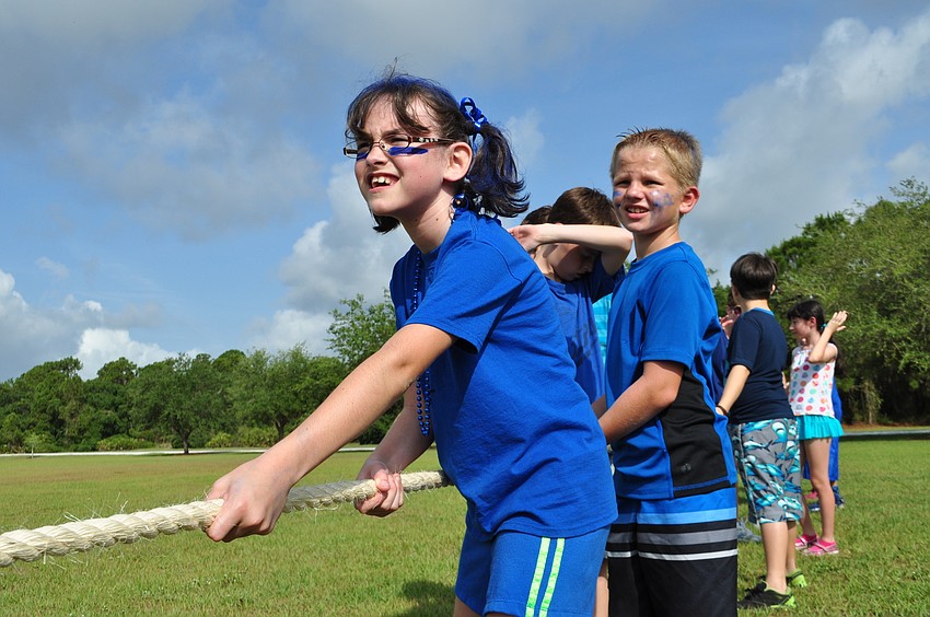 Lilly Riggs helps lead the blue team to victory in a tug-of-war matchup.