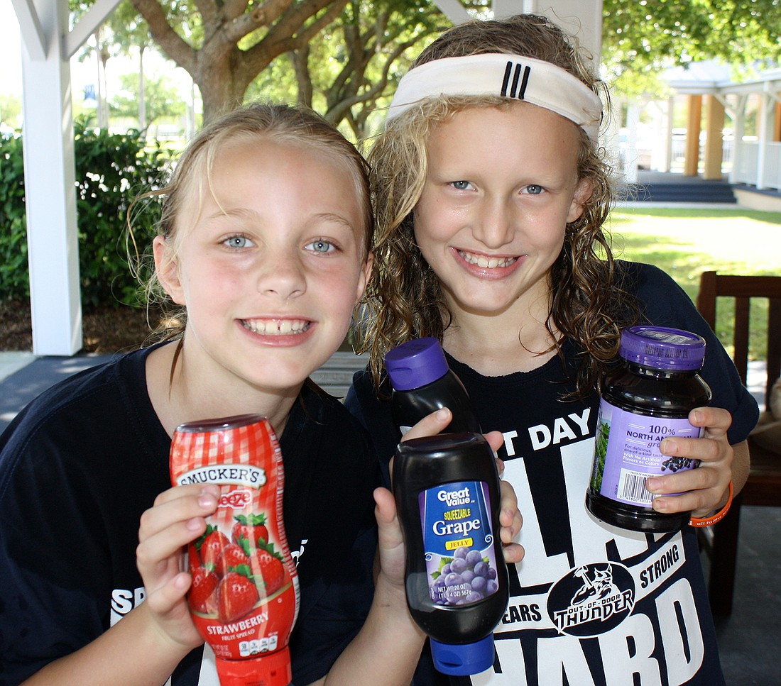 Courtesy photo. Members of the blue "jelly" team show off their donations for the Out-of-Door Academyâ€™s annual Peanut Butter and Jelly Food Drive Competition.
