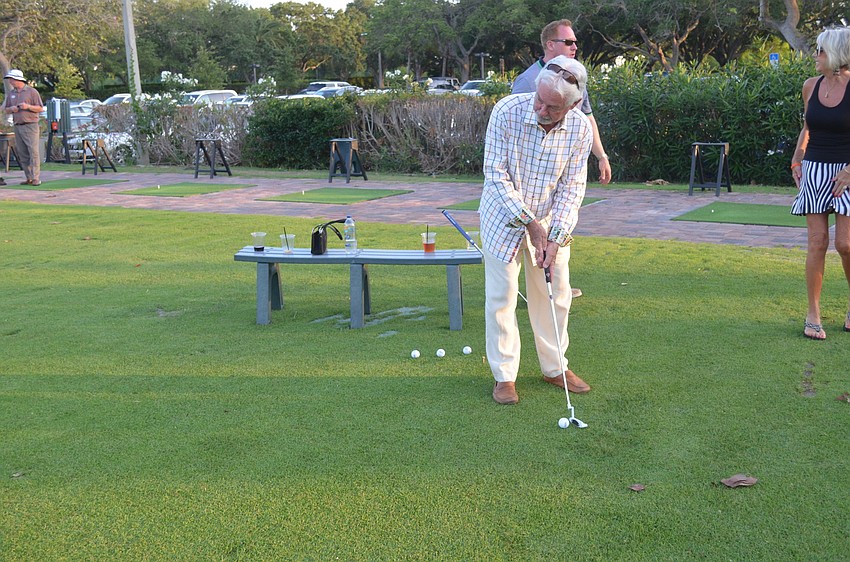 Jim Brown participates in the putting competition.