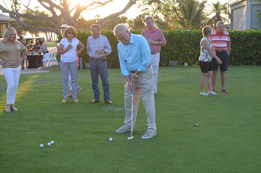 Jack Black participates in the putting competition.