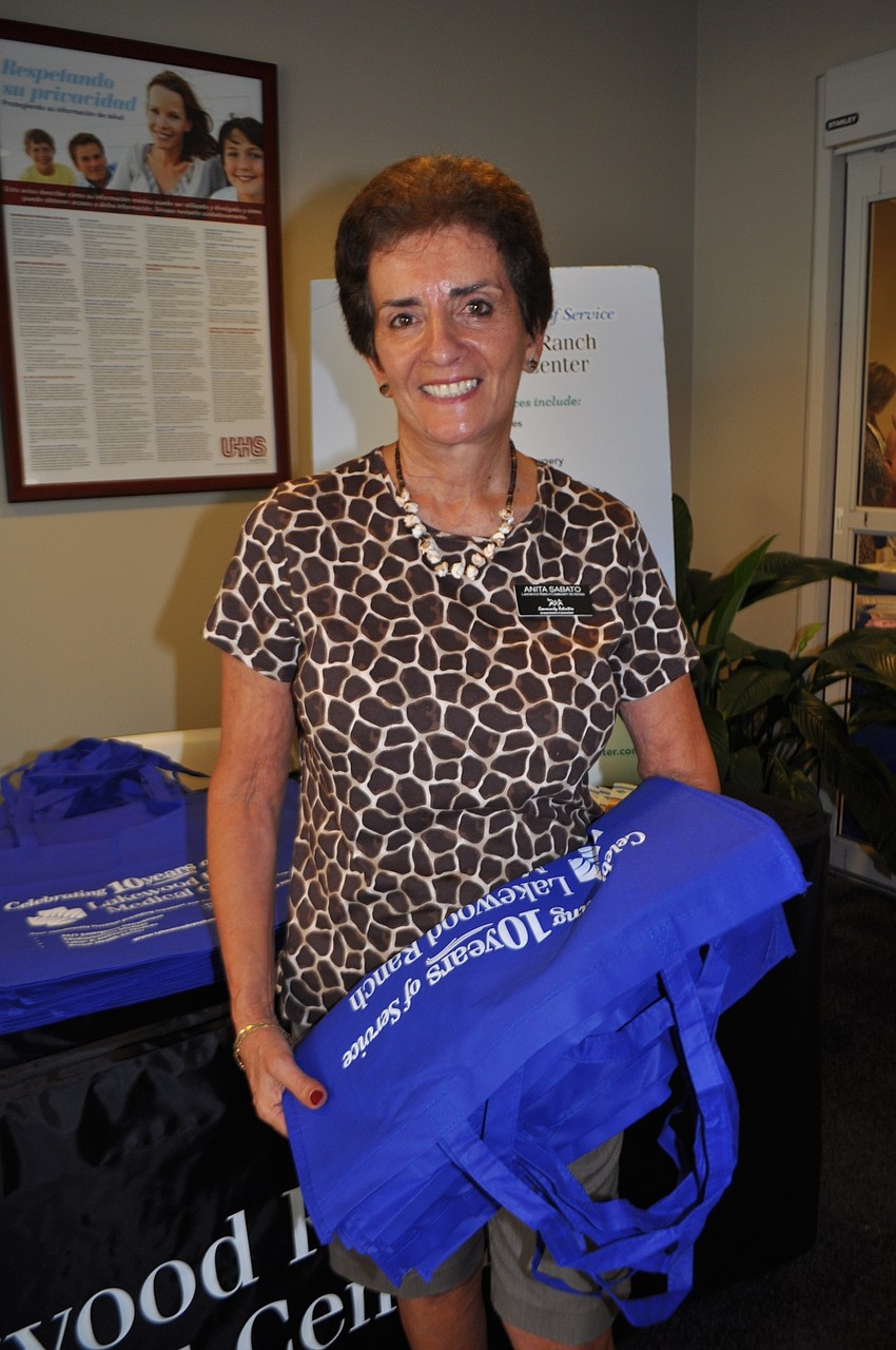 Anita Sabato, a board member on Lakewood Ranch Community Activities Corp., passes out reusable bags.