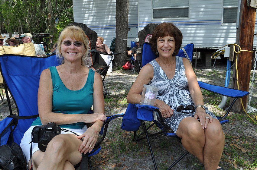 Jayne Folger and Pam Rowe watch their husbands perform.