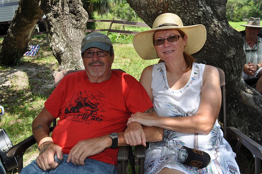 Gary and Lisa Glidden sit in the shade.