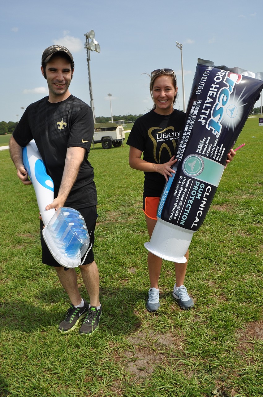 Lake Erie College of Osteopathic Medicine dental students Curtis Dugas and Samantha Seitz walk with props.