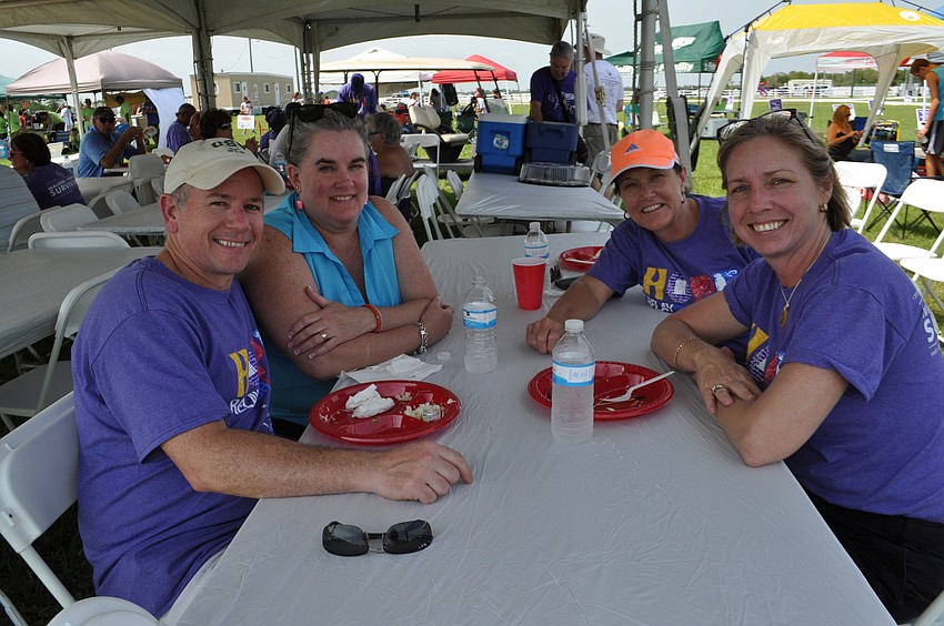 Survivor Jim Norton and his wife, Lisa, eat with fellow survivors Katy Kimbrell, back right, and Nicole Gulsby, front right.